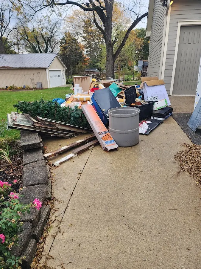 Dumpster being loaded with debris for Estate Cleanout Dumpster Rental in Lincoln